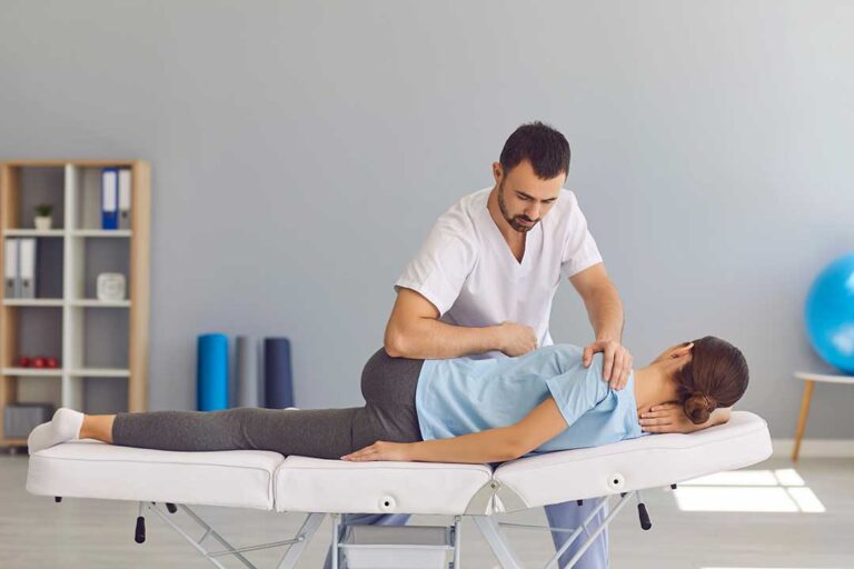 A chiropractor discussing a care plan with a local adult patient in a comfortable healthcare office.